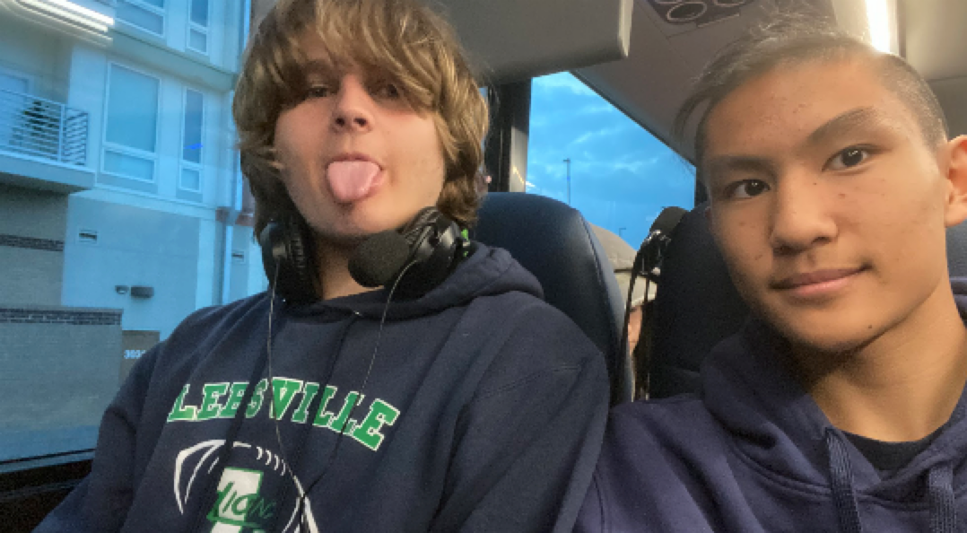 Trey and a friend on a bus, making faces at the camera.