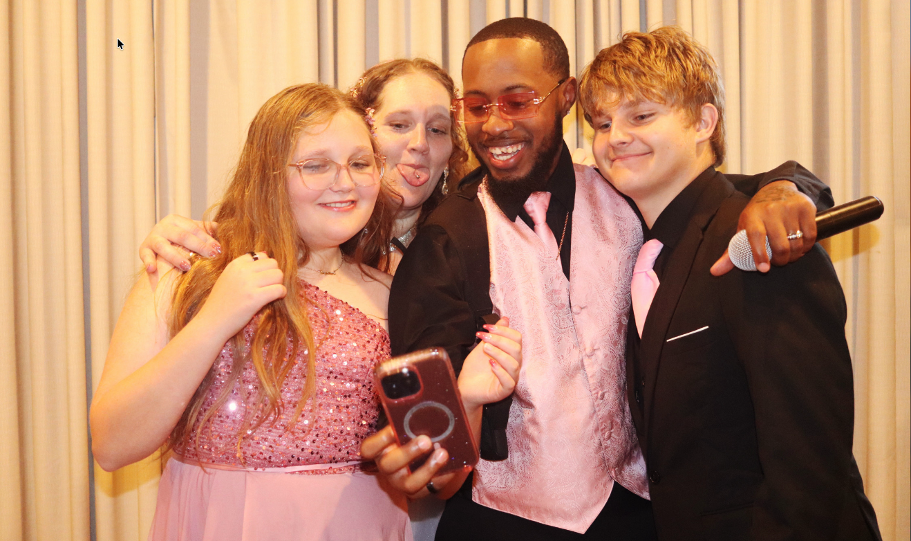 Trey with family, dressed up and laughing together before a dance.